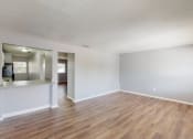 Thumbnail 4 of 17 - a living room with hardwood floors and grey walls