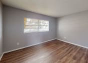 Thumbnail 12 of 17 - a dining room with hardwood floors and white walls
