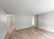 Thumbnail 6 of 17 - a bedroom with hardwood floors and grey walls