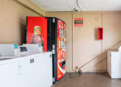 Thumbnail 14 of 19 - laundry facility with washers and vending machine