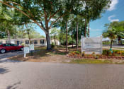 Thumbnail 7 of 9 - a mobile home park with a red car parked in front of it