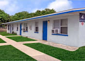 Thumbnail 11 of 12 - A white building with blue trim and a sign that says 4.