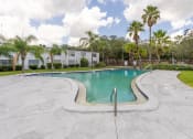 Thumbnail 16 of 19 - a swimming pool with palm trees at Bella Mar Apartments