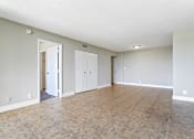 Thumbnail 8 of 33 - an empty living room with a tile floor and white walls at Fairways of Inverrary, Lauderhill, FL