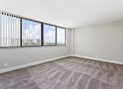 Thumbnail 12 of 33 - an empty living room with a large window at Fairways of Inverrary, Lauderhill, Florida