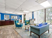 Thumbnail 20 of 33 - a lobby with couches and chairs and a reception desk at Fairways of Inverrary, Lauderhill, 33319