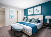 Thumbnail 10 of 33 - a bedroom with a bed and a blue wall and a closet at Fairways of Inverrary, Lauderhill, 33319