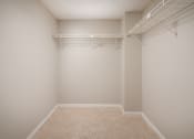 Thumbnail 15 of 33 - an empty bedroom with a large closet with a hanging rack on the wall at Fairways of Inverrary, Florida, 33319