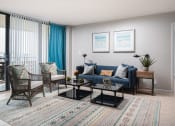 Thumbnail 5 of 33 - a living room with a blue couch and two chairs at Fairways of Inverrary, Lauderhill, Florida