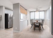 Thumbnail 2 of 33 - a kitchen and dining room with a table and a refrigerator at Fairways of Inverrary, Florida, 33319