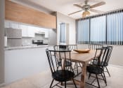 Thumbnail 1 of 33 - a kitchen and dining room with a wooden table and chairs at Fairways of Inverrary, Lauderhill, 33319