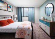 Thumbnail 11 of 33 - a bedroom with a bed and a mirror at Fairways of Inverrary, Lauderhill, FL