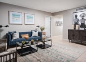 Thumbnail 6 of 33 - an open living room with a blue couch and a coffee table at Fairways of Inverrary, Florida