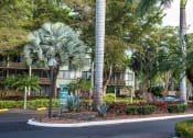 Thumbnail 28 of 33 - a street with palm trees in front of an apartment building at Fairways of Inverrary, Florida