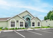 Thumbnail 29 of 31 - Clubhouse exterior with parking lot_Rolling Hills Apartments