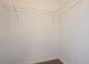 Thumbnail 10 of 31 - A white wall with a metal rack on it.