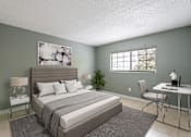 Thumbnail 4 of 19 - A bedroom with a large bed, a desk, and a chair.