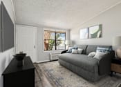 Thumbnail 3 of 15 - A living room with a grey couch, a black cabinet, and a rug.