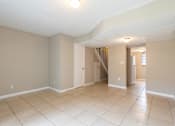 Thumbnail 12 of 39 - a living room with a tiled floor and a staircase in the background at Del Rio Apartment