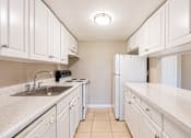 Thumbnail 8 of 39 - a kitchen with white cabinets and white countertops at Del Rio Apartment