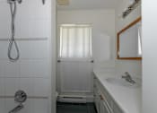 Thumbnail 49 of 64 - a bathroom with a shower and a sink