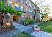 Thumbnail 1 of 16 - a brick building with a red ``for lease' sign in front of it