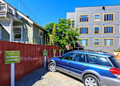 Thumbnail 5 of 16 - a car parked in front of a fence with a sign that reads reserved parking