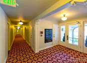 Thumbnail 3 of 16 - a corridor with yellow walls and red carpet