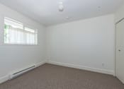 Thumbnail 46 of 64 - a bedroom with white walls and carpet
