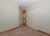 Thumbnail 17 of 64 - a bedroom with two closets and a door to a bathroom