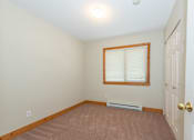 Thumbnail 19 of 64 - a bedroom with a window and a door