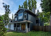 Thumbnail 1 of 64 - a home with a black exterior and a brown front door