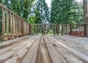 Thumbnail 3 of 64 - a deck with a wooden floor