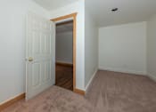 Thumbnail 12 of 64 - a bedroom with an open door and a carpeted floor