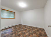 Thumbnail 26 of 64 - an empty room with a window and a door