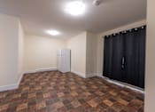 Thumbnail 31 of 64 - an empty room with a refrigerator in the corner