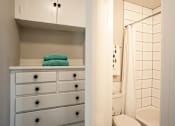 Thumbnail 13 of 16 - a bathroom with a white cabinet and a toilet