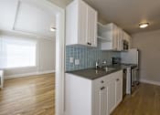 Thumbnail 16 of 16 - a kitchen with white cabinets and a sink and a window