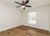 Thumbnail 11 of 18 - an empty bedroom with a ceiling fan and a window