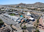 Thumbnail 94 of 96 - A large building complex with a parking lot in front of it at Presidio Palms Apartments, Tucson, 85701
