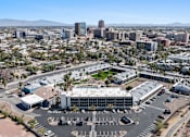 Thumbnail 95 of 96 - A large building with a parking lot in front of it at Presidio Palms Apartments, Tucson, Arizona