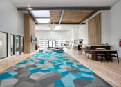 Thumbnail 7 of 95 - a large lobby area with a geometric rug at Presidio Palms Apartments, Tucson, Arizona