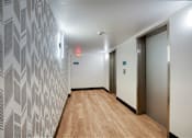 Thumbnail 83 of 95 - A hallway with a wooden floor and a wallpapered wallat Presidio Palms Apartments, Arizona, 85701