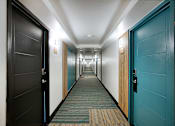 Thumbnail 84 of 95 - A long hallway with colorful features at Presidio Palms Apartments, Tucson