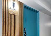 Thumbnail 73 of 95 - A blue door leading to a unit at Presidio Palms Apartments, Arizona