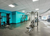 Thumbnail 17 of 95 - a gym with weights and cardio equipment at Presidio Palms Apartments, Tucson, 85701
