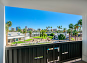 Thumbnail 82 of 95 - A view of a city skyline from a balcony at Presidio Palms Apartments, Arizona