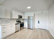 Thumbnail 87 of 95 - A modern kitchen with white cabinets and stainless steel appliances at Presidio Palms Apartments, Tucson, AZ