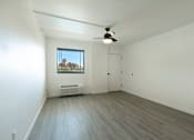 Thumbnail 86 of 95 - Spacious room with a ceiling fan and a window at Presidio Palms Apartments, Tucson, AZ