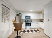 Thumbnail 22 of 95 - a kitchen with white cabinets and stainless steel appliances at Presidio Palms Apartments, Tucson, AZ, 85701
